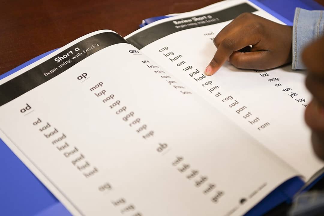 Notasulga Elementary School second grader Jordan Jackson follows along in her book with her teacher during a reading intervention exercise on March 15, 2023, in Notasulga, Alabama.